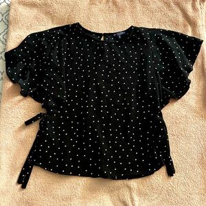 Black T-shirt with white stars, ruffle sleeves, and ties at sides